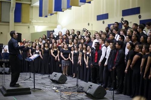 A choir being lead by a conductor